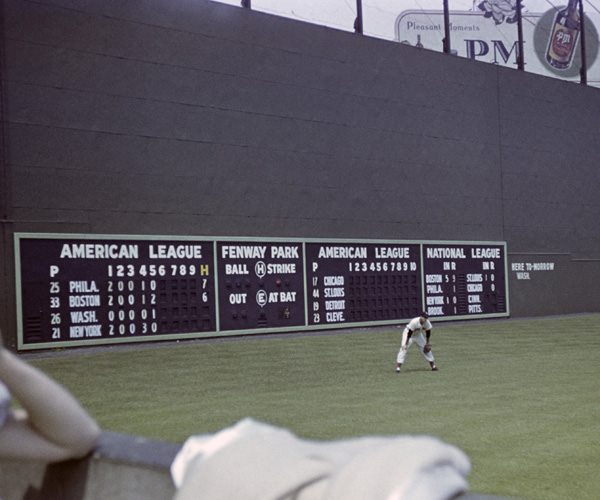 Fenway Park, Boston, MA, July 4, 1947 – Red Sox great Ted Williams in left field with the freshly painted Green Monster behind him