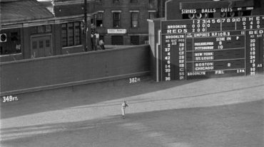 Crosley Field, Cincinnati, Ohio, July 20, 1950 – Dodgers’ Jim Russell playing in the shadows of a iconic scoreboard during a Thursday doubleheader